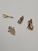 4 9ct gold charms to incl. mandolin, frog, bull fighter and a mandala hand, 4.88