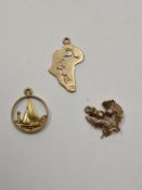 3 9ct gold charms, a sailing boat, Scottish Thistle and Africa, 4.5g