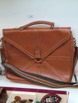 A modern tan leather satchel with shoulder strap, having internal Mulberry label