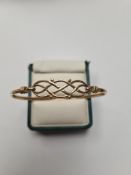 9ct yellow gold bangle with openwork hinged panel, 6cm diameter, marked 375, Birmingham, maker SD, a