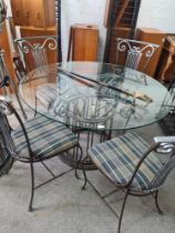 A modern metalwork dining table having circular glass top and a set of four matching chairs, all wit
