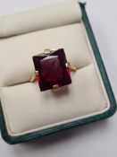 18ct yellow gold cocktail ring set with large mixed cut ruby, 13mm x 12mm in 4 claw mount marked 18c