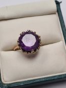 Unmarked yellow gold dress ring, set with large round cut amethyst, 12.2g Size L, 4.37g