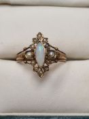 Antique 9ct yellow gold dress ring set with marquise cabouchon opal framed with panels inset with se