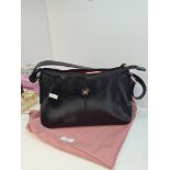 A Radley black leather handbag and protective drawstring Radley cover