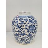 A Chinese blue and white ginger jar having allover decoration of birds and butterflies, four charact