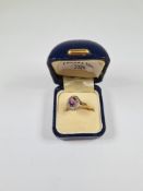 18ct and Platinum Cluster ring, with central oval mixed cut amethyst, surrounded small diamond chips