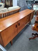 A vintage E Gomme G-plan large sideboard having four drawers, 206cms (damage to folding door on righ
