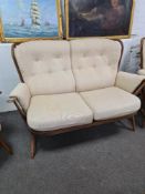 A Vintage Ercol stickback two seat settee and pair of matching armchairs