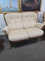 A Vintage Ercol stickback two seat settee and pair of matching armchairs