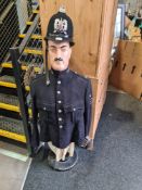 A half mannequin of man wearing Metropolitan Police Jacket and Hampshire Constabulary helmet