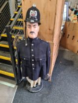 A half mannequin of man wearing Metropolitan Police Jacket and Hampshire Constabulary helmet