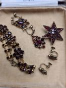 A collection of Victorian bohemian garnet set jewellery including bangle star brooch, 2 pairs of ear