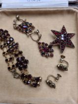 A collection of Victorian bohemian garnet set jewellery including bangle star brooch, 2 pairs of ear