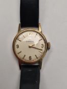Omega; 9ct gold cased ladies Omega watch with champagne dial, baton markers and numbers, on black le