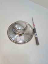 A silver inkwell on a spread circular base, hallmarked worn, possibly William Hutton and Sons, 1927.