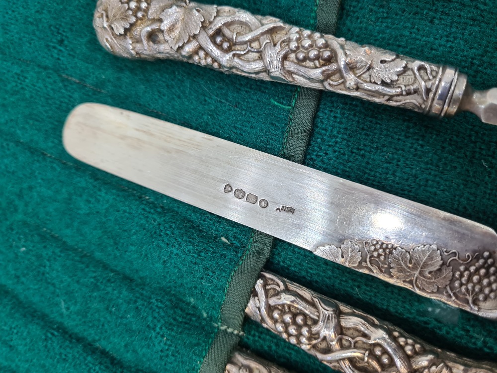 A set of six Victorian silver fruit knives and forks, with heavily embossed handles of vines and gra - Image 3 of 12