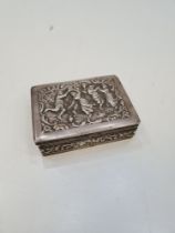A Dutch second standard silver ornate box of intricate design showing an embossed scene of figures d
