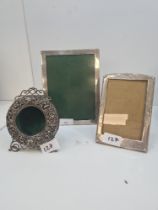 A silver rectangular frame by London 1988 Laurence R Watson and Co, with another smaller frame havin