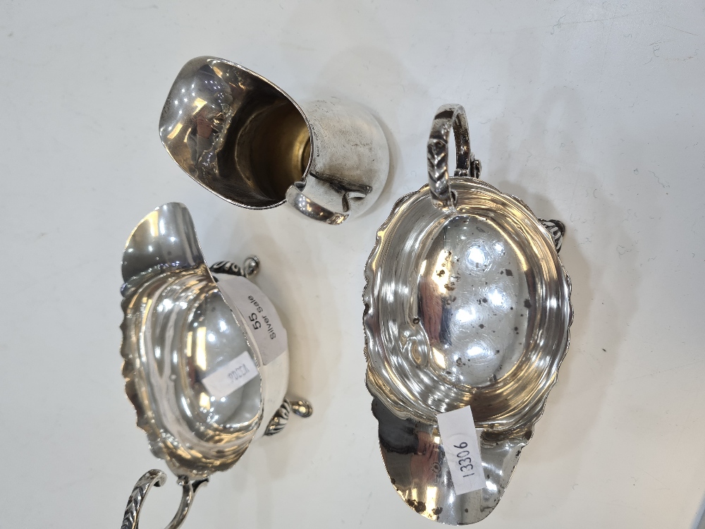 A pair of silver creamers, having scallop design rim, acanthus leaf handle, and embossed feet hallma - Image 12 of 14
