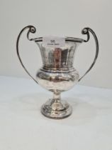 A silver trophy cup of baluster form, having two handles, raised pedestal base and engraved name bod