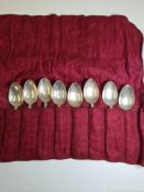 A set of eight silver teaspoons having heavily embossed bordered handles of floreated and foliate de