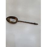 A Victorian silver spoon having ornate handle terminating with a figure on the finial. Engraved and