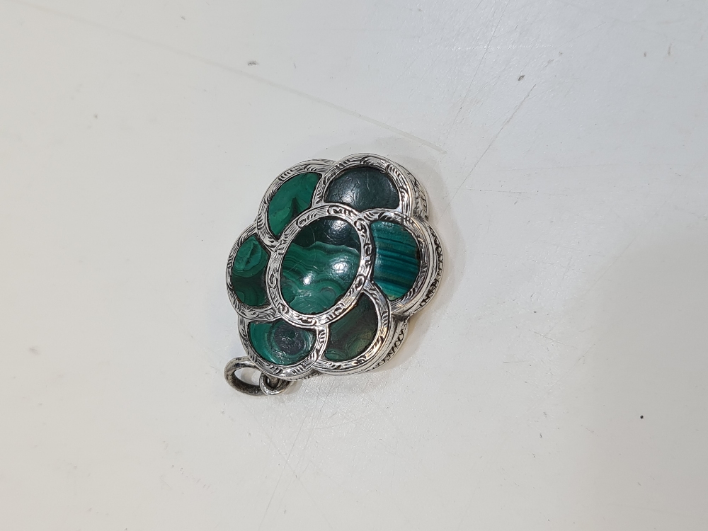 A very pretty silver vinaigrette of flower form, having green stone lid and heavily decorated base o