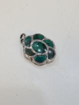 A very pretty silver vinaigrette of flower form, having green stone lid and heavily decorated base o
