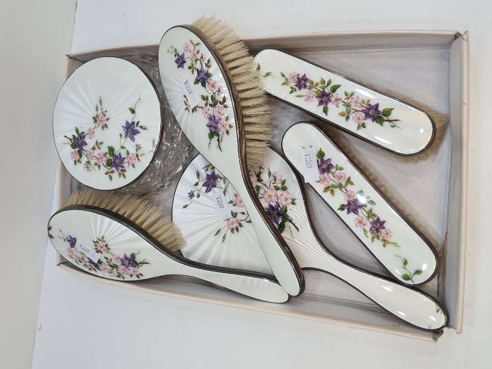 Garrard and Co Ltd., a stunning silver and enamel dressing table set consisting of brushes, a mirror