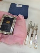 A silver rectangular photo frame hallmarked Birmingham 1993, P J Panton. 11cm x 8cm approx. Also wit