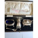 A cased silver cruet set hallmarked Birmingham 1928, Docker and Burn Ltd., with Bristol Blue insets,