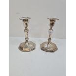 A pair of Hawksworth Eyre and Co Ltd silver candlesticks, having octagonal moulded pedestal bases, o