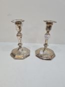 A pair of Hawksworth Eyre and Co Ltd silver candlesticks, having octagonal moulded pedestal bases, o