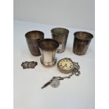 White metal cups with various marks on the bases, a silver decanter label and a silver cup by Philip