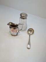 A silver topped sugar sifter having cut glass body and silver top having circular pierced details. H