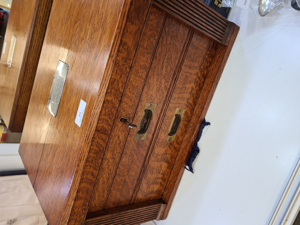 Two drawer oak cutlery cabinet, with raised lid and wing foot, fitted for 81 pieces silver flatware,