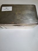 A silver cigarette box of rectangular form, having stripped lid with 'K' initialled in the centre. H