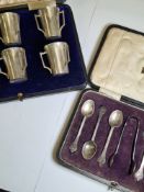 Cased silver teaspoons and sugar tong, excluding one teaspoon, having decorative handle ends, hallma