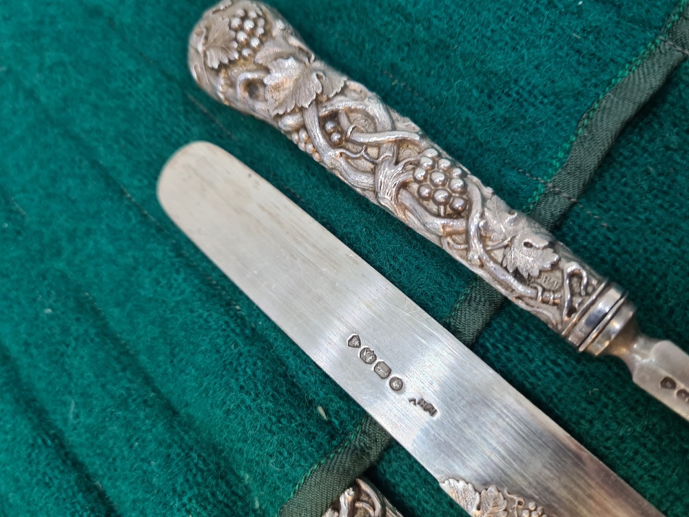 A set of six Victorian silver fruit knives and forks, with heavily embossed handles of vines and gra - Image 6 of 12