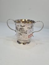 A large Georgian silver two handled cup having gilt interior and embossed body of flowers, in low re