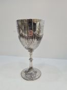 A large silver trophy cup having half gadroon style body, and beaded border on the foot. Engraved na