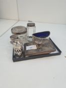 A mixed silver lot comprising of silver topped glass items, salt, pepper and other similar items. Th