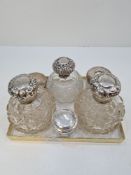 Silver topped dressing table items comprising silver topped pretty cut glass scent bottles and other