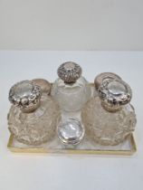 Silver topped dressing table items comprising silver topped pretty cut glass scent bottles and other