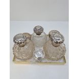 Silver topped dressing table items comprising silver topped pretty cut glass scent bottles and other