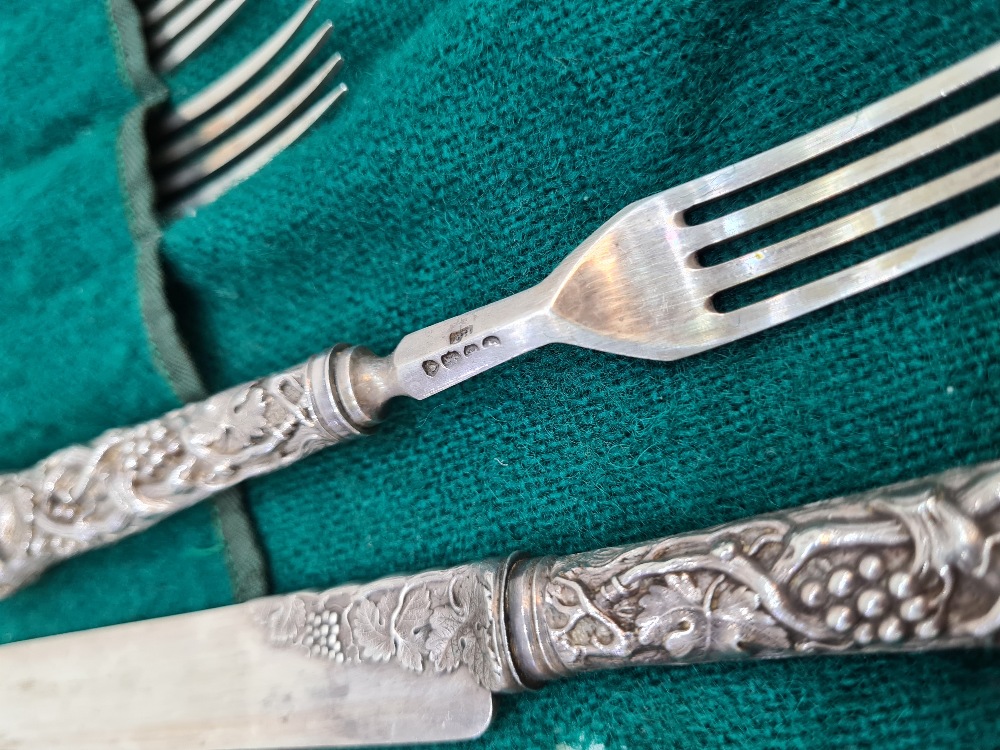 A set of six Victorian silver fruit knives and forks, with heavily embossed handles of vines and gra - Image 8 of 12