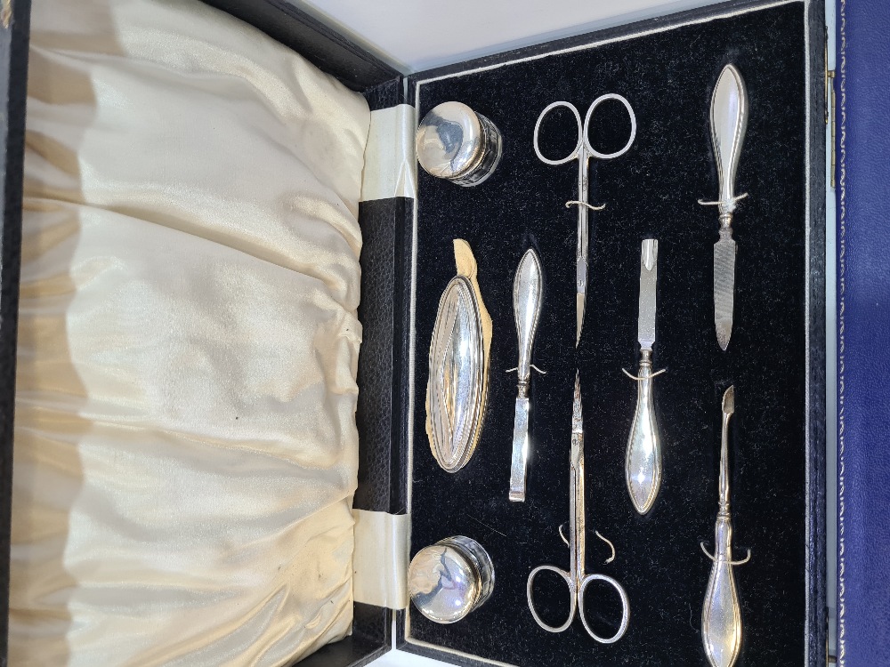 A boxed manicure set by Hanset and Harper Ltd., Birmingham 1926. Comprising silver handled items, gl