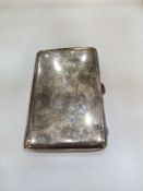 A heavy silver cigarette case of larger form, having gilt interior, hallmarked Birmingham 1919 Charl