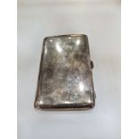 A heavy silver cigarette case of larger form, having gilt interior, hallmarked Birmingham 1919 Charl